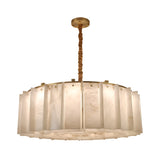The Lunaro 12 Light Circular Panel Alabaster Chandelier in Brushed Brass & Soft White features vertical alabaster panels in a circular design, suspended from a brushed brass rod for an elegant look and a warm, soft glow.