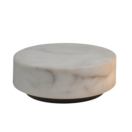 The Alurien LED Large Alabaster Coffee Table in Soft White features a round, sculptural design with a smooth alabaster surface and subtle veining, set on a dark, recessed base against a white background.