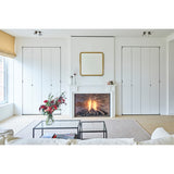 Diva Square 95cm gold beaded-frame wall mirror above a white mantel fireplace in a living room with white panelled cabinetry.