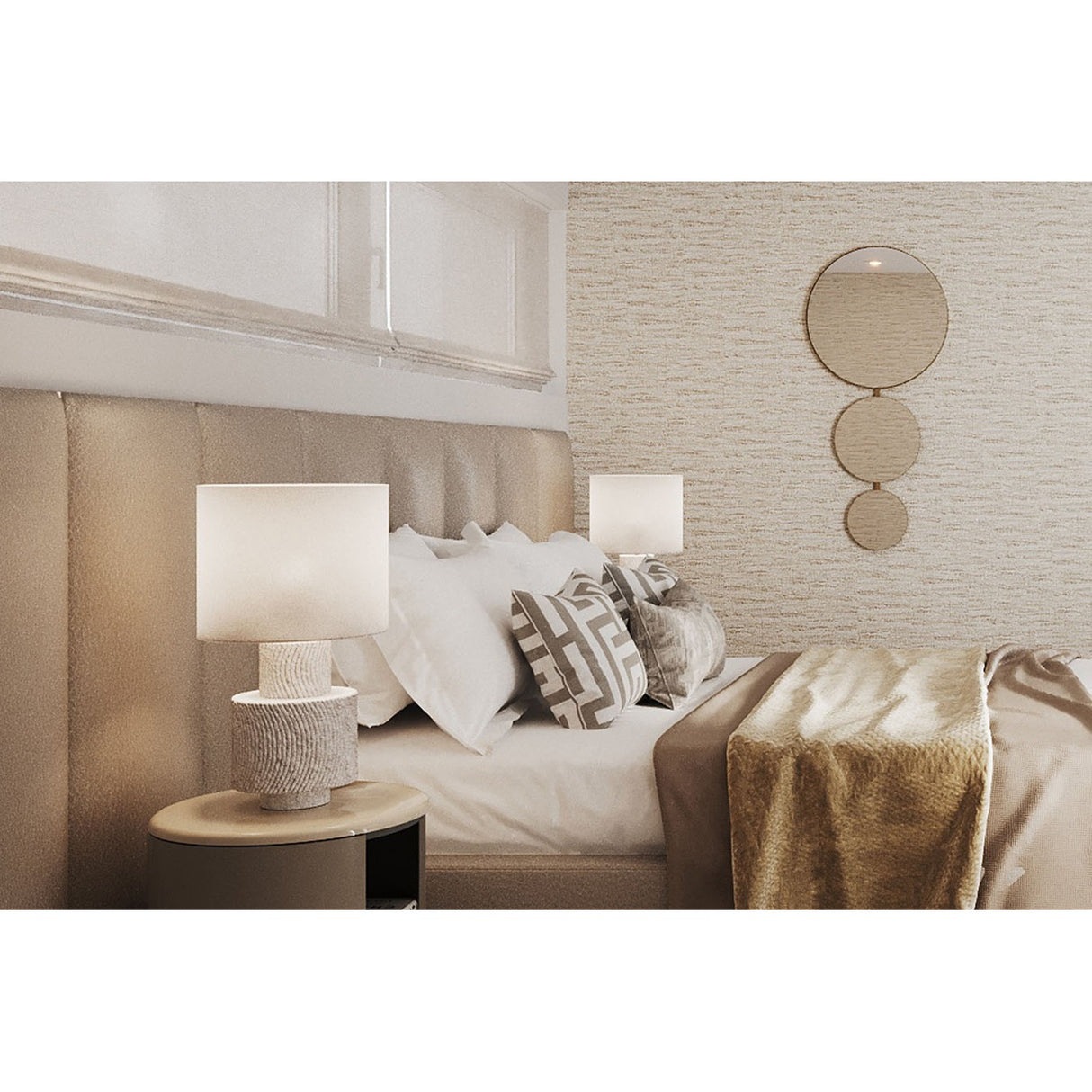 Opera Three Circle Gold Rimmed Wall Mirror 119cm mounted above a bedside table in a bedroom, three joined gold-rimmed circular mirrors decreasing in size top to bottom.