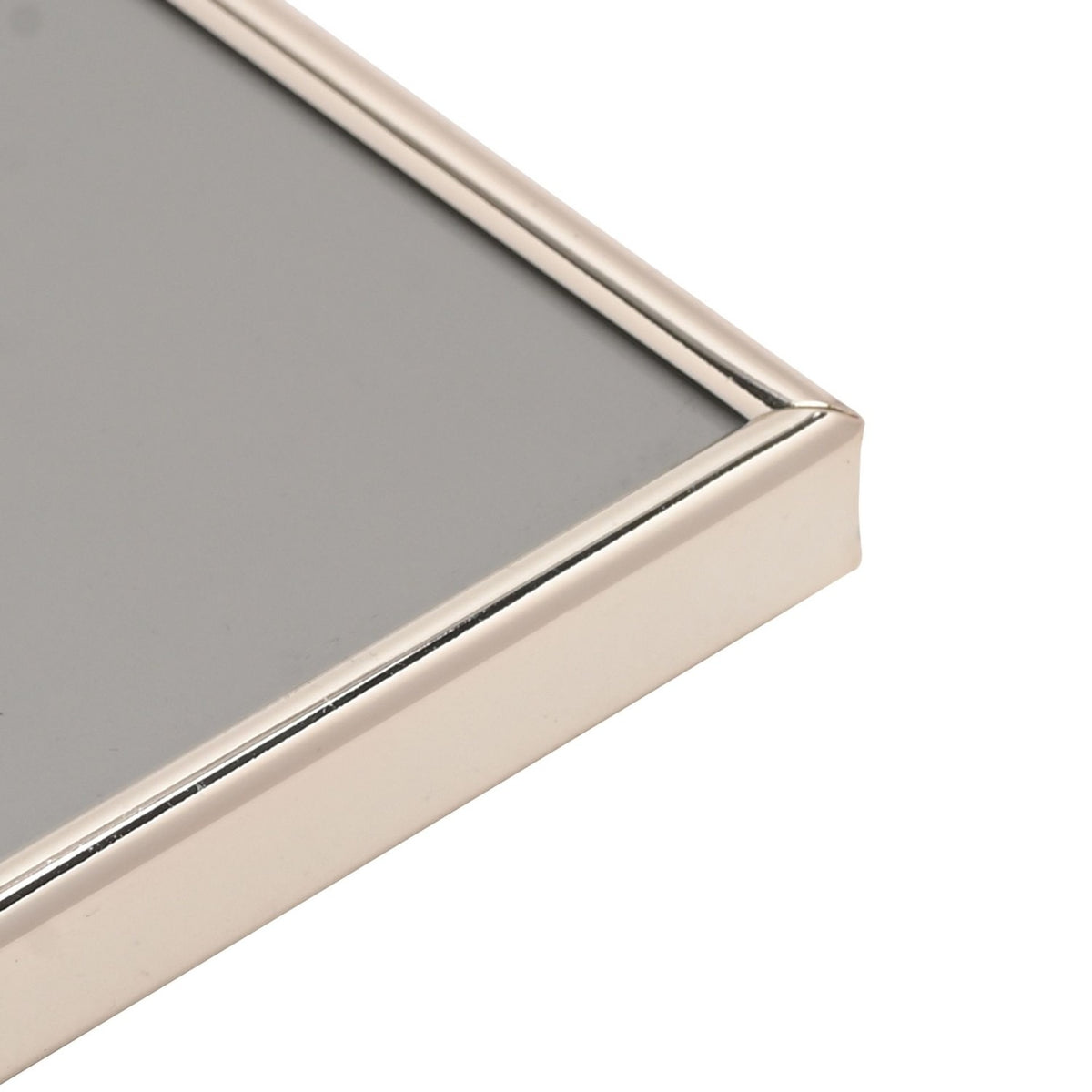 Close-up corner view of the Thin Oblong Silverplated Metal Photo Frame 6 x 4in, showing its slim rounded silver edge and grey insert on a white background.