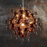 Endon Brockford 9 Light Cluster Pendant in copper, with smoked mirror and tinted glass spheres clustered on plated metalwork against a dark backdrop.