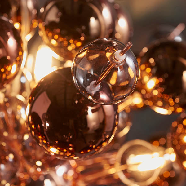 Close-up of Endon Brockford 9 Light Cluster Pendant in copper, showing clustered smoked mirror and tinted glass spheres on plated metalwork with warm glow.