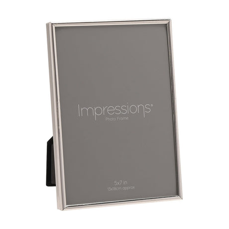 Thin oblong silver-plated metal photo frame for a 7 x 5in print, shown at an angle with grey insert card on a plain white background.
