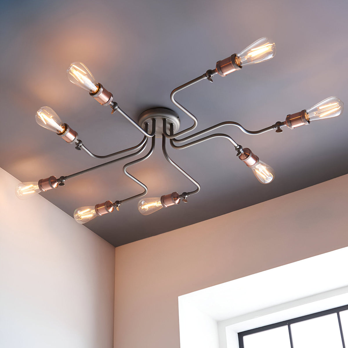 Brackley 8 Light Semi-Flush Ceiling Light in pewter, metal arms with copper-toned holders and exposed bulbs, shown mounted on a bedroom ceiling.