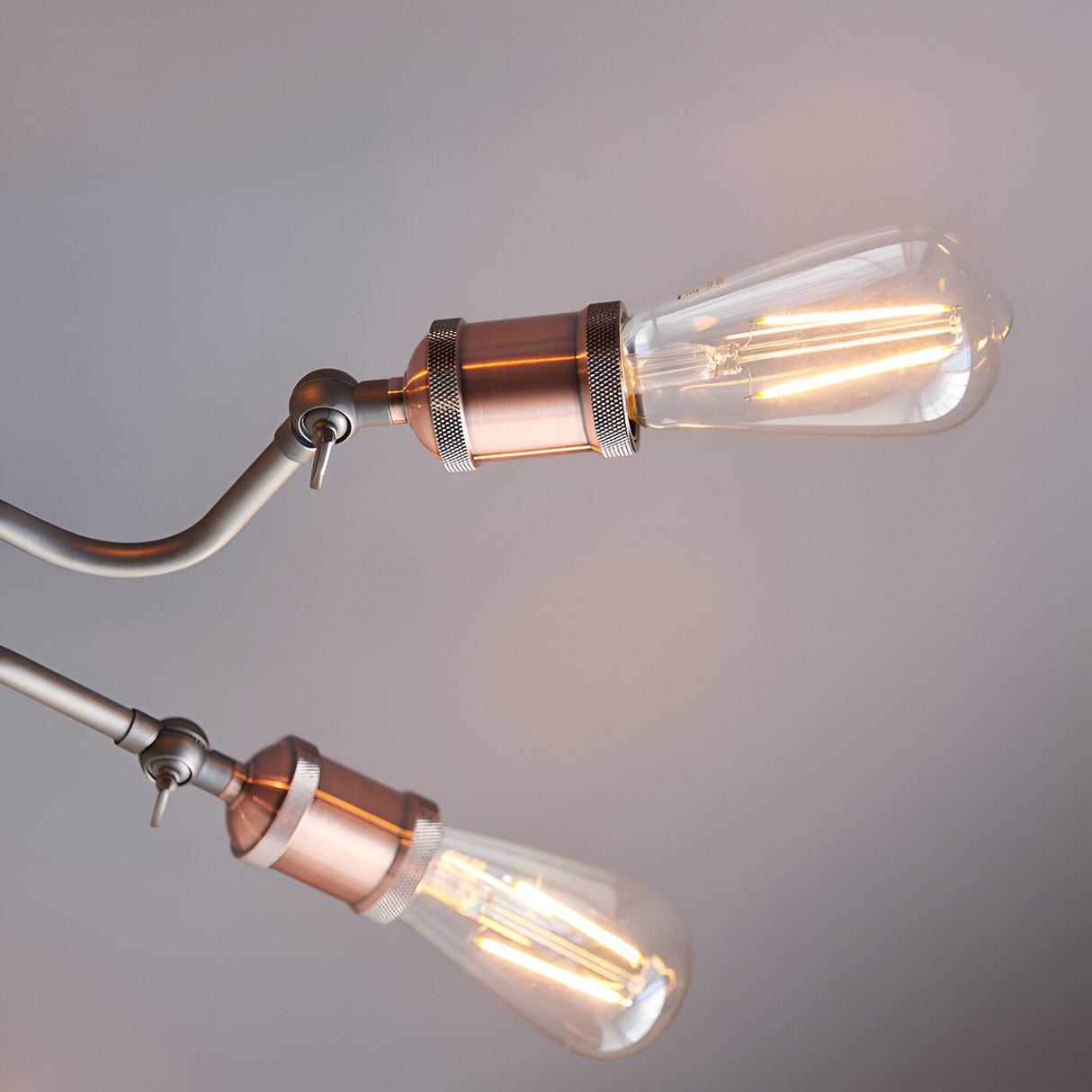 Brackley 8 Light Semi-Flush Ceiling Light with pewter arms, knurled copper-finish E27 lampholders, and exposed filament bulbs.