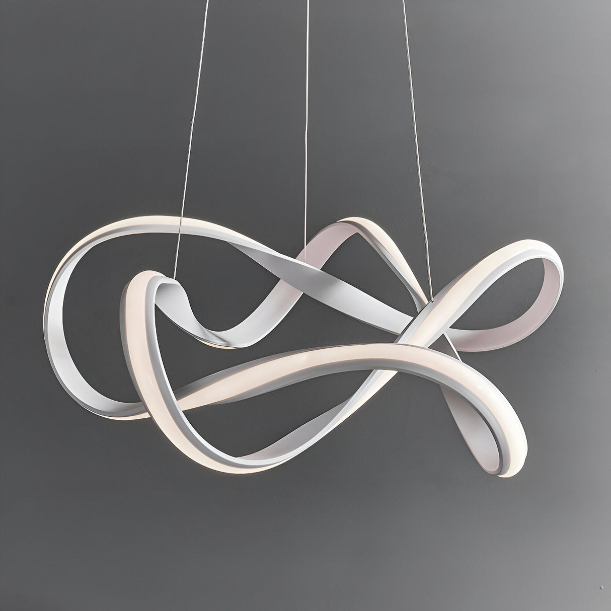 Endon Crancombe pendant light in matt sand white, featuring a sculptural free-flowing LED ribbon form suspended on delicate wires against a grey background.