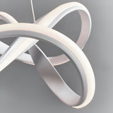 Close-up of the Endon Crancombe LED pendant showing its looping matt white sculptural form and softly glowing diffuser against a grey background.