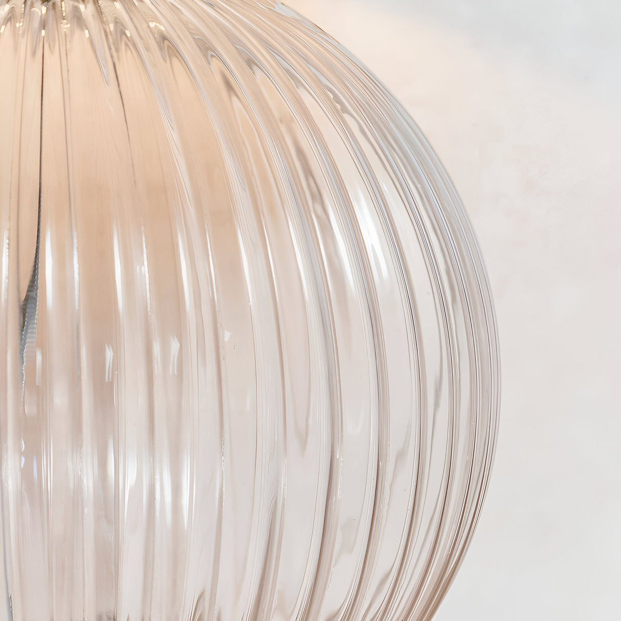 Close-up of the Endon Brockdale table lamp base showing clear ribbed glass with satin nickel detailing against a light neutral background.