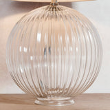 Endon Brockdale table lamp base with clear ribbed globe glass and satin nickel neck, shown on a wooden surface beneath a fabric shade.