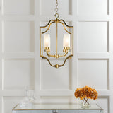 Endon Brackford 4 light pendant in satin brass with shaped frame and frosted glass shades, hung above a mirrored console with dried hydrangeas.