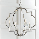 Bramfield 4 Light Pendant in polished nickel with quatrefoil frame, crystal bobeches and candle-style bulbs, hung against a white panelled wall.