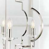Close-up of the Bramfield 4 Light Pendant in polished nickel, showing candle bulbs on glass bobeches with curved metal arms against a white background.