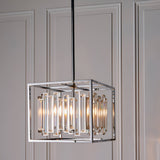 Endon Aldbourne 4 light pendant with square polished chrome frame and bevelled glass crystals, suspended from a rod against panelled walls.