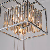 Endon Aldbourne 4 light square pendant in polished chrome with tiered bevelled glass crystals, shown illuminated from below against a pale ceiling.