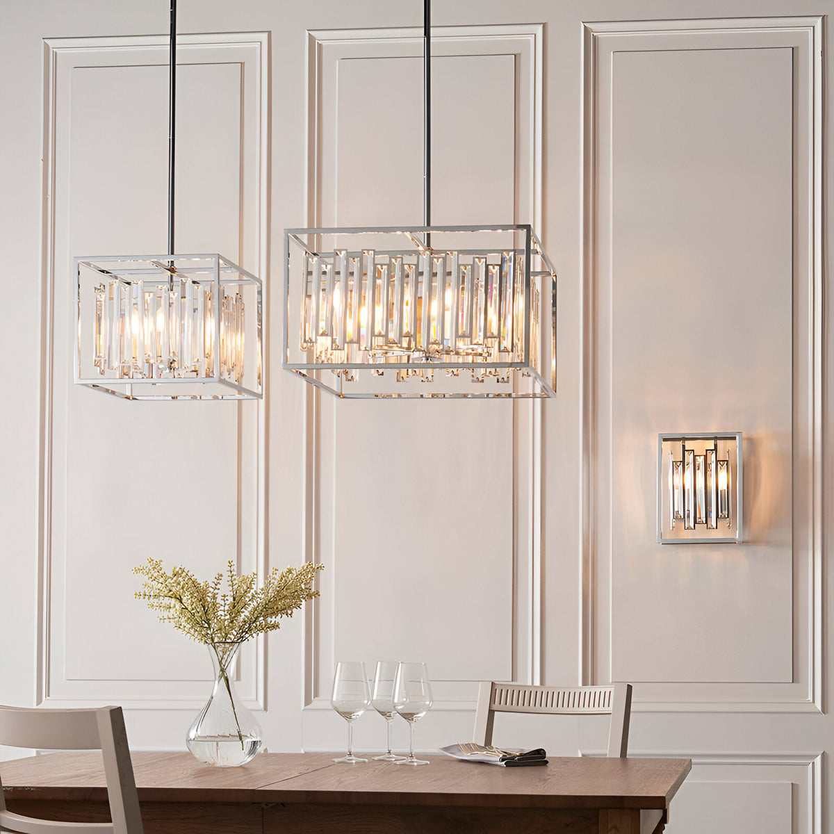 Aldbourne 6 Light Pendant in polished chrome with bevelled crystal glass panels, shown in a dining room alongside a matching wall light.