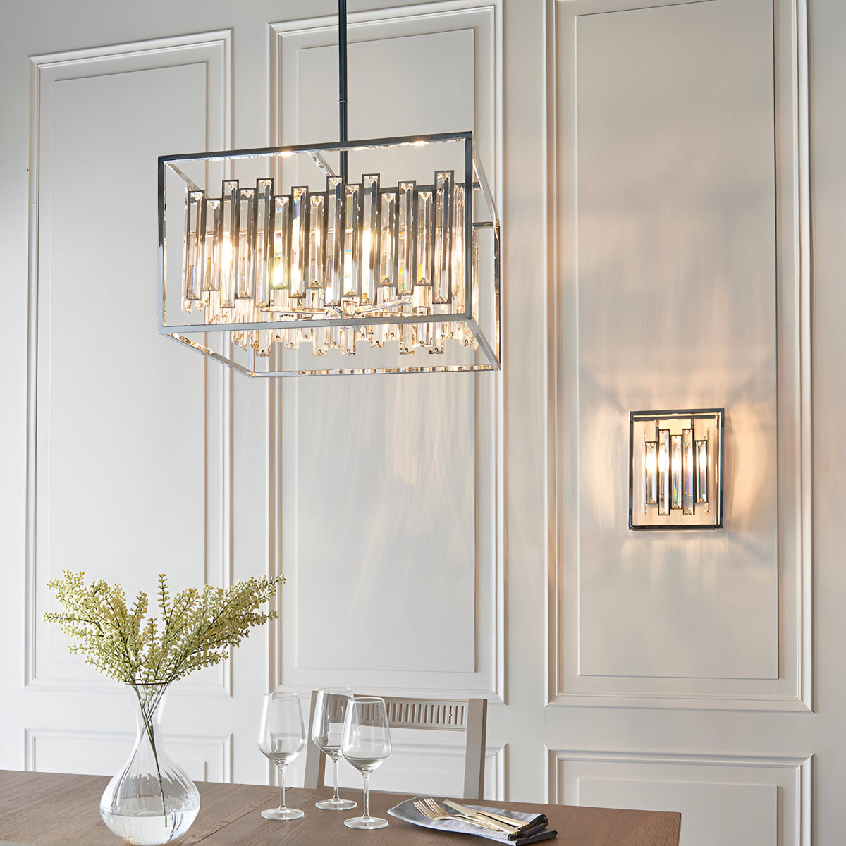 Aldbourne 6 Light Pendant in chrome with rectangular frame and bevelled crystal glass rods, shown above a dining table alongside a matching wall light.