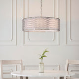 Endon Rosaline 3 light pendant in satin nickel with circular geometric fretwork outer and white fabric inner, hanging above a marble dining table.
