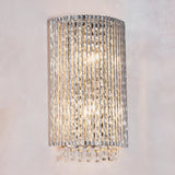 Endon Isadora 2 light wall light with twisted polished chrome rods and K9 clear crystal droplets, illuminated against a plain neutral wall.