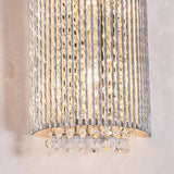 Endon Isadora 2 light wall light in polished chrome with twisted rods and clear K9 crystal droplets illuminated against a neutral wall.