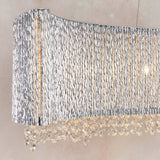 Endon Isadora linear pendant close-up showing twisted polished chrome rods forming a wave shade with clear crystal droplets suspended beneath.
