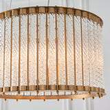 Cliffdale 6 Light Pendant in matt gold, drum-shaped frame with twisted clear glass rods glowing from within, close-up on a white background.