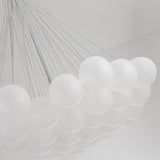 The Orb 37 Light Cluster Suspension - Silver features frosted white spheres suspended by thin wires in a geometric design, offering a modern frosted glass chandelier look ideal for contemporary spaces.
