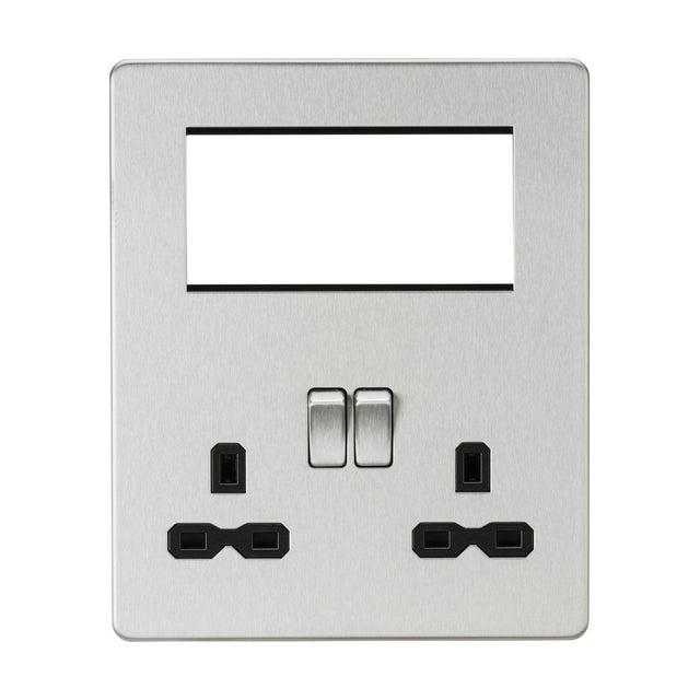 The Small Multimedia Combination Plate - Brushed Chrome (Black Insert) features a sleek, metallic wall design without visible screws. It includes two rocker switches and two sets of three-pin power sockets. The top section has an empty rectangular slot for modular inserts, perfect for USB charging or other components.