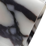 Close-up of the Orvani 1 Light Veined Marble Single Pendant Light in white with black marble-like veining; its smooth, polished surface and curved edge create a striking modern sculptural statement.