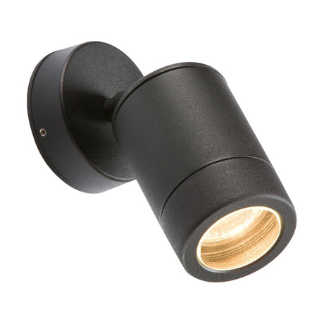 The Outdoor Adjustable Wall Light - Black is a black, cylindrical GU10 wall light fixture featuring a glowing bulb that can be angled to direct light downwards. Made from stainless steel, it showcases a minimalist design that is securely mounted on the wall with a round base and comes with an IP65 rating for durability in different weather conditions.