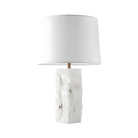 The Kavryn 1 Light Raw Cut Alabaster Table Lamp features a brass and soft white finish, with a textured rectangular alabaster base and a large white drum shade, showcased against a plain white background.