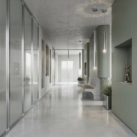 A modern, minimalist hallway with polished concrete floors, glass panel walls, built-in seating, decorative plants, sculptures in wall niches, and the Micro LED Pendant Light - Silver for a sophisticated contemporary accent.
