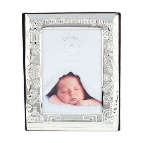 Silverplated My Christening Day photo album with a rectangular picture-window frame, raised title lettering, and embossed baby motifs including blocks, teddy bear, rattle, and bottle.