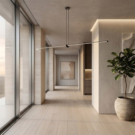 A modern hallway with light wood floors, large windows, a sculptural plant, abstract art, and the Minimo LED Small Bar Suspension Light in black uses neutral tones and sleek lighting to create a calm, minimalist vibe.