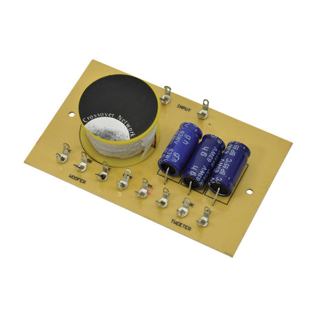 QTX 2-way crossover network PCB with inductor coil and three blue capacitors, labelled input, woofer and tweeter terminals, on a plain white background.