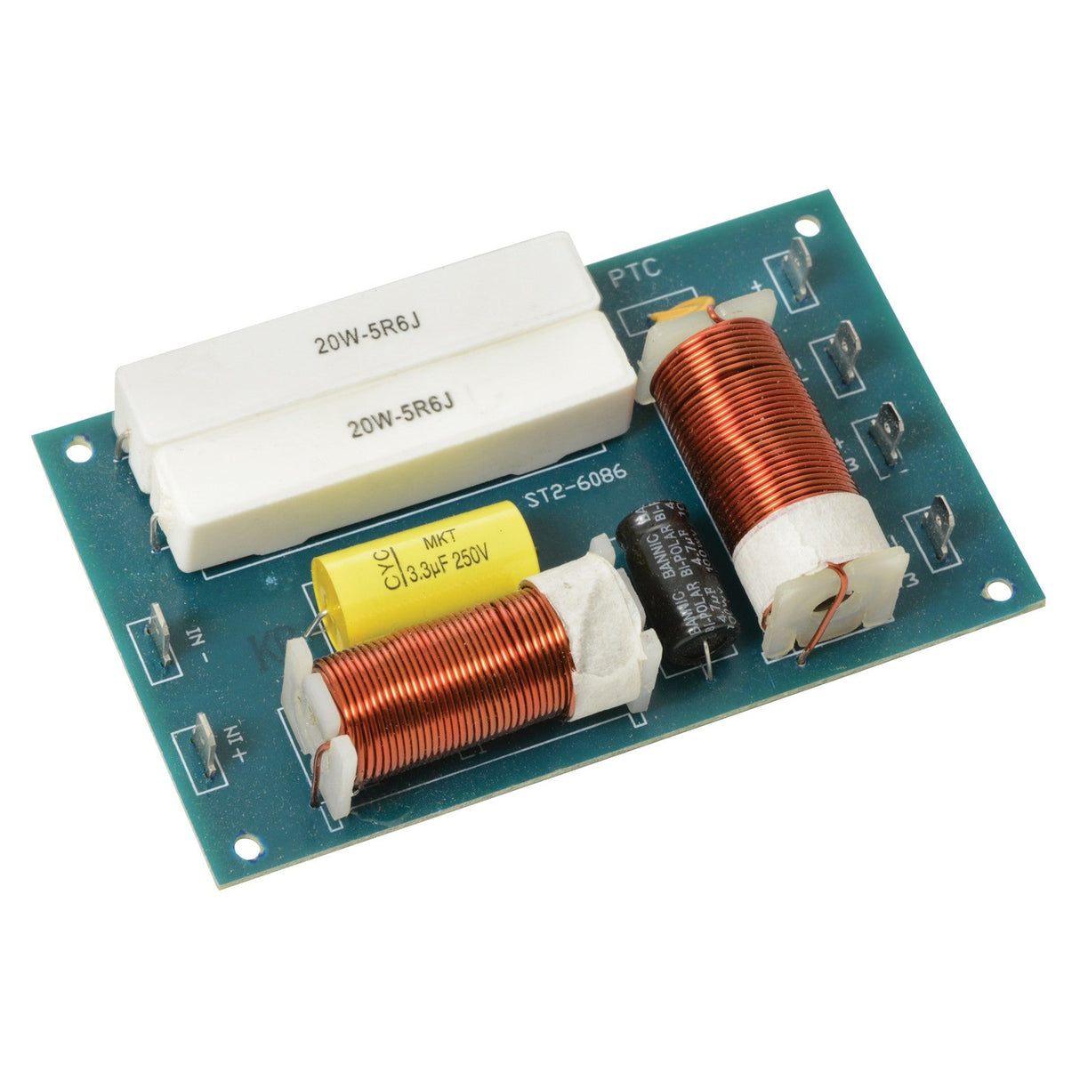 The QTX 2-Way Crossover features a close-up view of a green circuit board with two prominent copper coils, two white resistors labeled 20W-5R6J, and a yellow capacitor marked 3.3uF 250V. This configuration is optimized for sound reproduction in crossovers. A black cylindrical capacitor on the board efficiently manages high frequencies through multiple connection points.