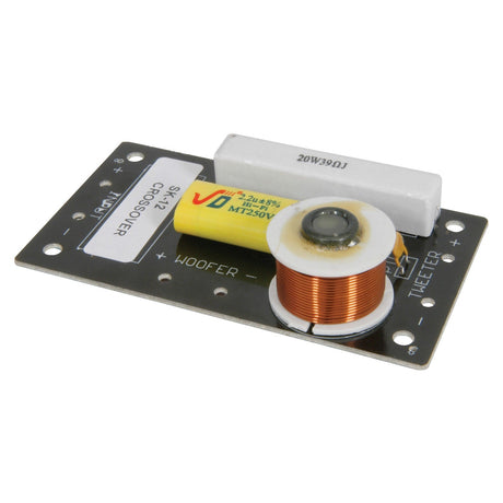 The QTX CROSSOVER NETWORK FOR QR12 is a rectangular printed circuit board that includes a large copper coil, a yellow cylindrical component, and a rectangular white block labeled 20W39OH. Designed to handle 300W of power, this module is perfectly suited for the QR12 cabinet, featuring specific connections for the woofer and tweeter.