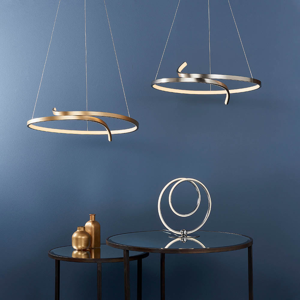 Endon Chartmont pendant in matt brushed gold, a slim looped ring with integrated LED, shown with a silver version above a mirrored side table.