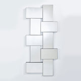 The panelled mirror seen larger, the panels stepping forward at different depths with openings between them.