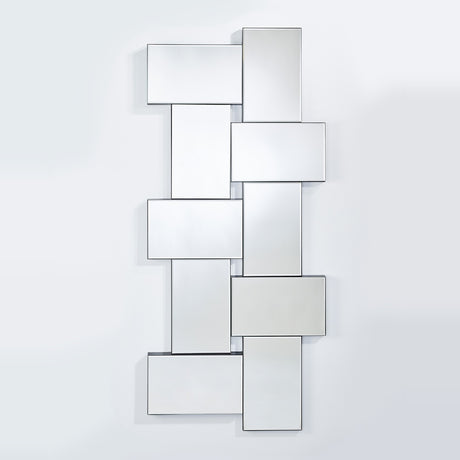 The panelled mirror seen larger, the panels stepping forward at different depths with openings between them.