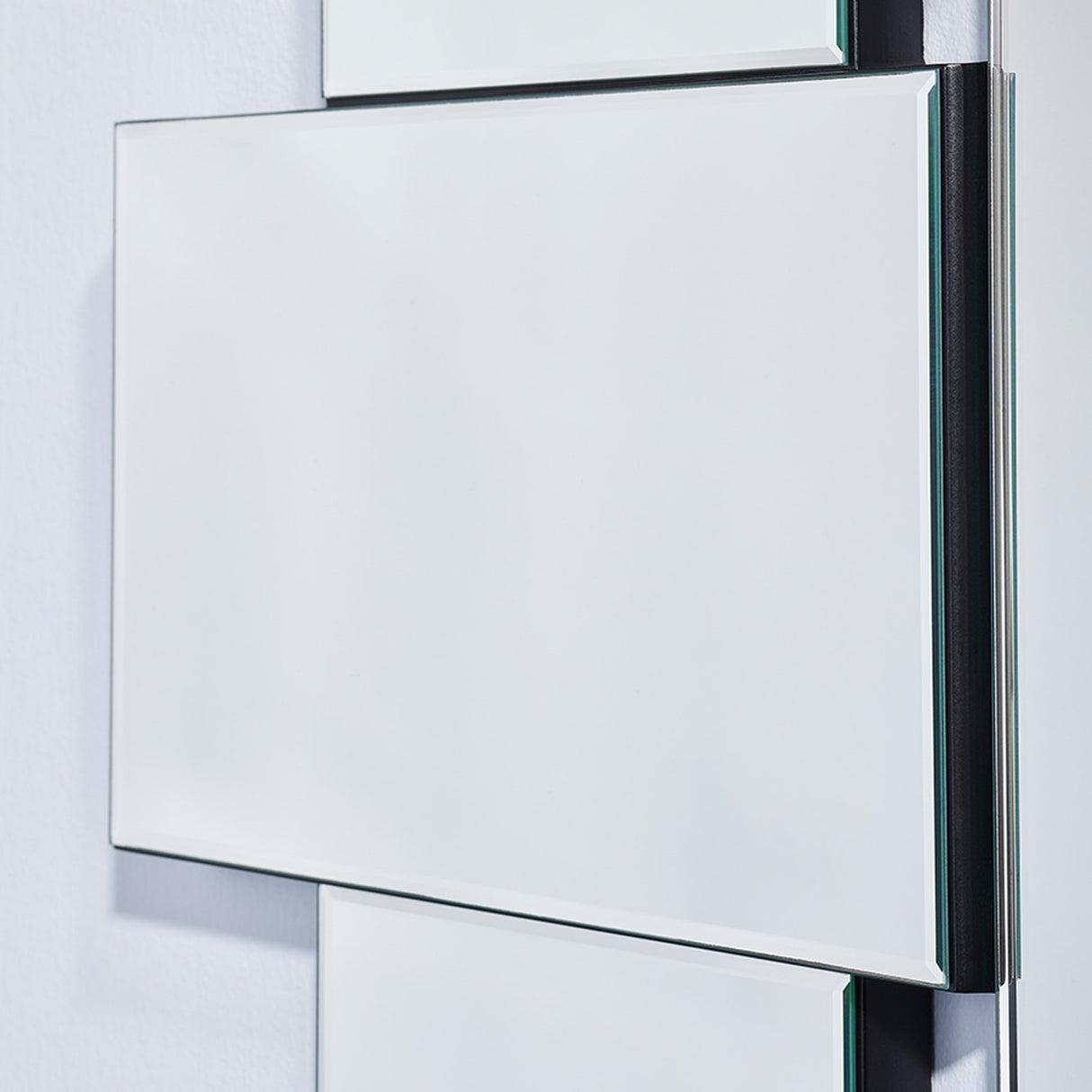 Close-up of a panel edge, showing the bevel and the matt black support carrying it behind.