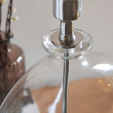 Close-up of the Endon Bramleigh table lamp showing its clear glass ellipsoid base and polished nickel stem fitting.