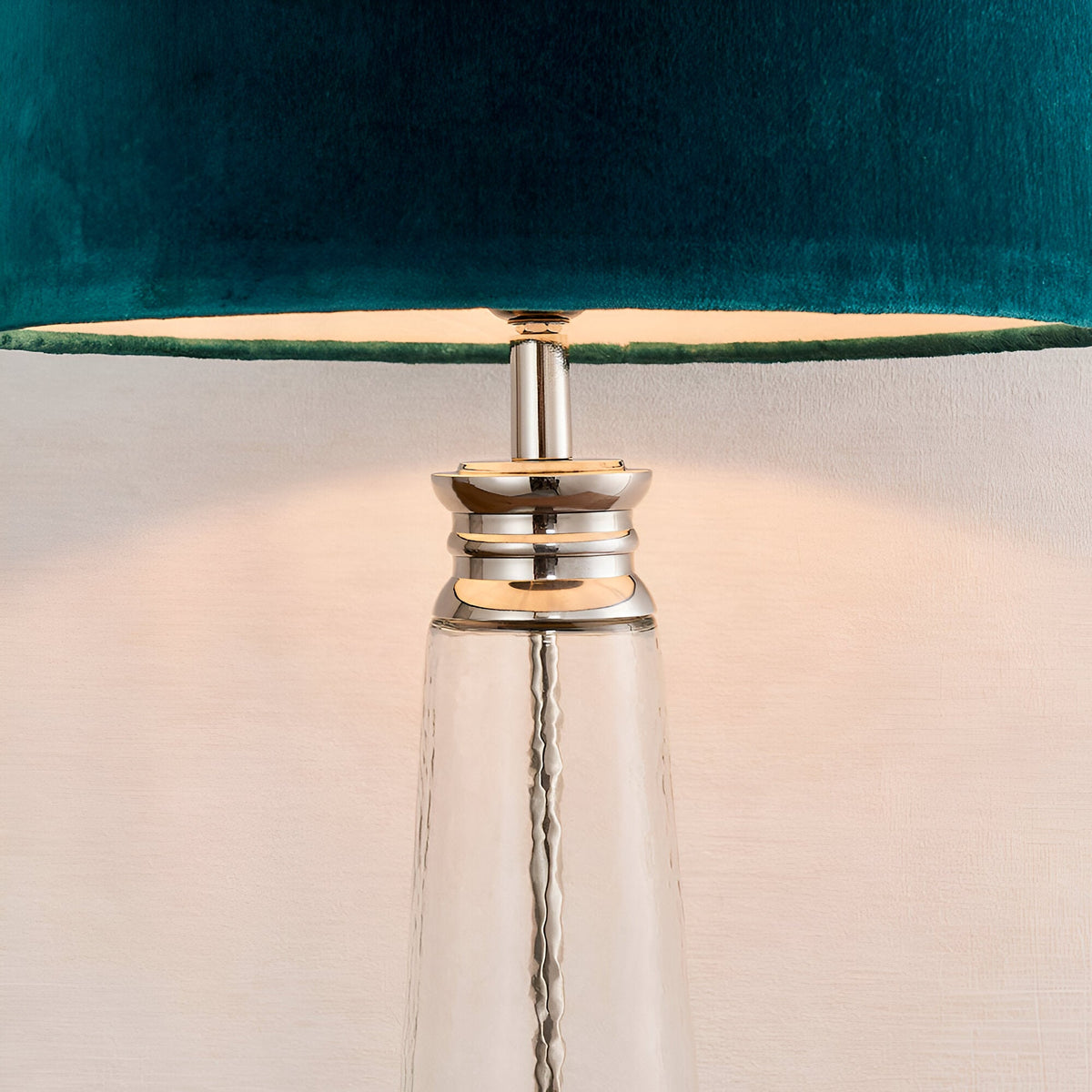 Close-up of Endon Danehurst table lamp showing hammered clear glass base with tiered nickel collar and teal velvet shade with silver lining.