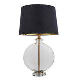 Endon Bramleigh table lamp with clear glass ellipsoid base, antique brass stem and tapered black faux suede shade, shown on a white background.