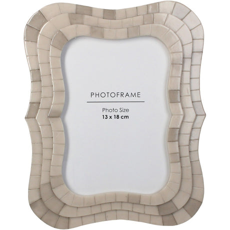 Libra Interiors Mosaic Tiled Resin Photo Frame in ivory with a scalloped wave-shaped surround and layered tile texture, holding a 13x18cm portrait image.