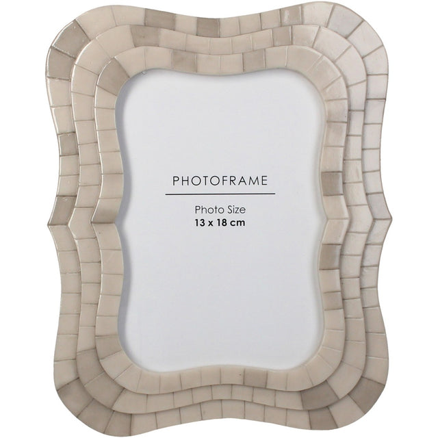 Libra Interiors Mosaic Tiled Resin Photo Frame in ivory with a scalloped wave-shaped surround and layered tile texture, holding a 13x18cm portrait image.