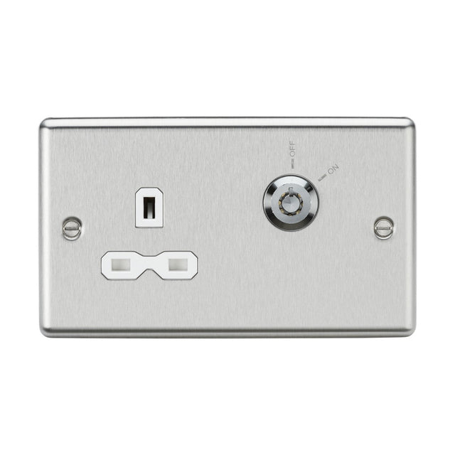 The brushed chrome 13A DP Key Lockable Socket, featuring a two-gang plate with white insert and rounded edges, includes a 230V double pole power outlet. It has two vertical slots and a round opening below. To the right, there is a key-operated switch labeled ON and OFF, providing enhanced security with its lockable socket design.