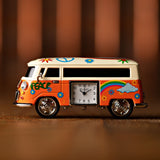 Miniature Camper Van Analogue Metal Mantel Clock in orange with cream roof, featuring a hand-painted "PEACE" lettering, flowers, rainbow and cloud design, side-set analogue clock face.