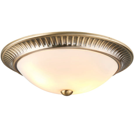Bravenne Flush Ceiling Light in antique brass with a fluted rim, frosted glass diffuser and small brass finial, shown on a plain white background.