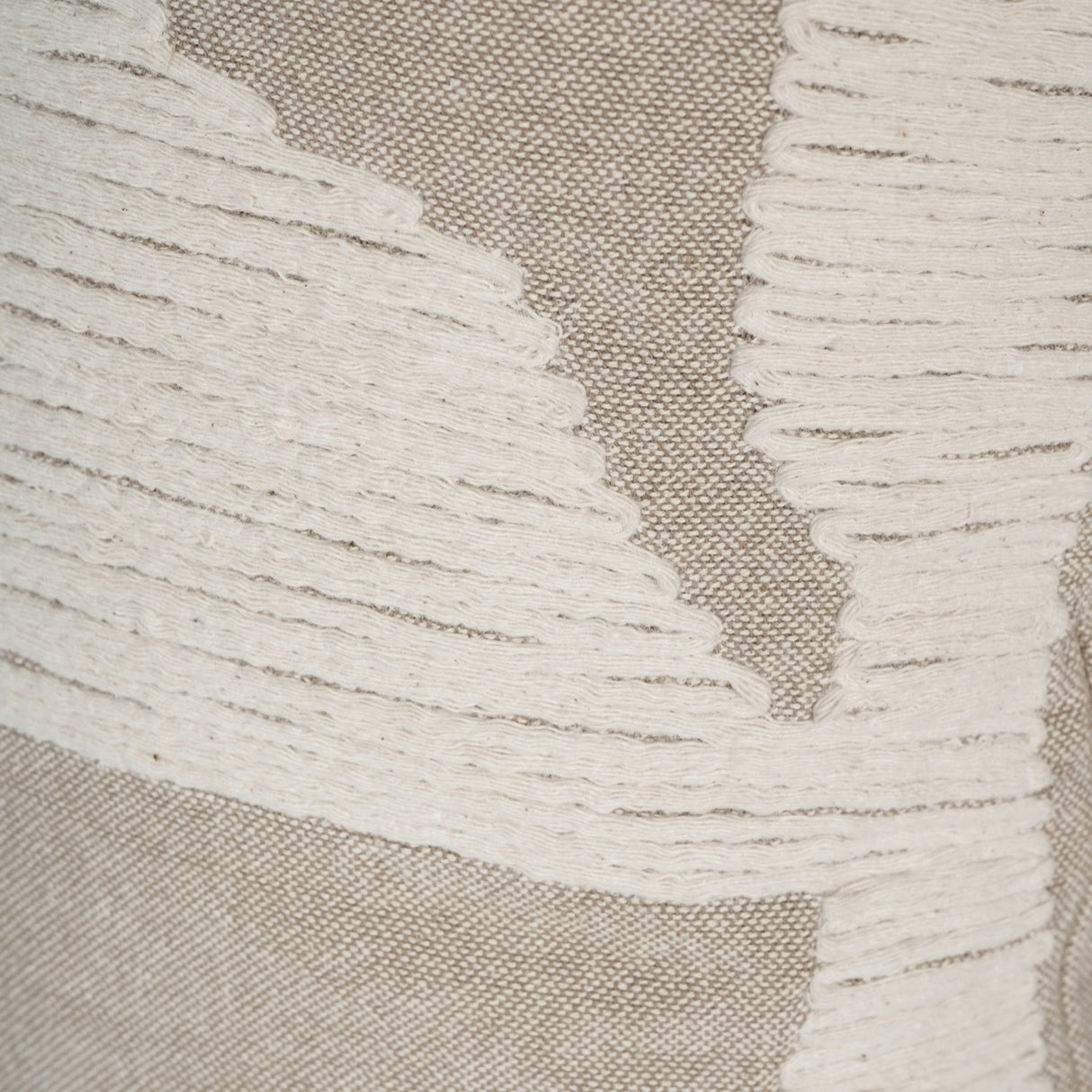 Close-up of Libra Interiors Textured Cotton 50cm Square Cushion in natural beige with raised cream stitched abstract lines on a woven cotton ground.